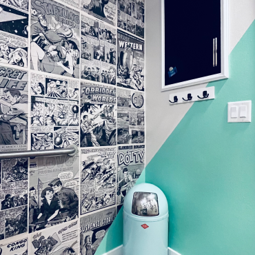 immersive comic wall collage retail space bathroom art